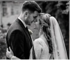 Black and white portrait of a bride and groom standing close together